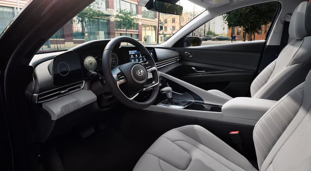 The light gray interior and dash of a 2023 Hyundai Elantra is shown.