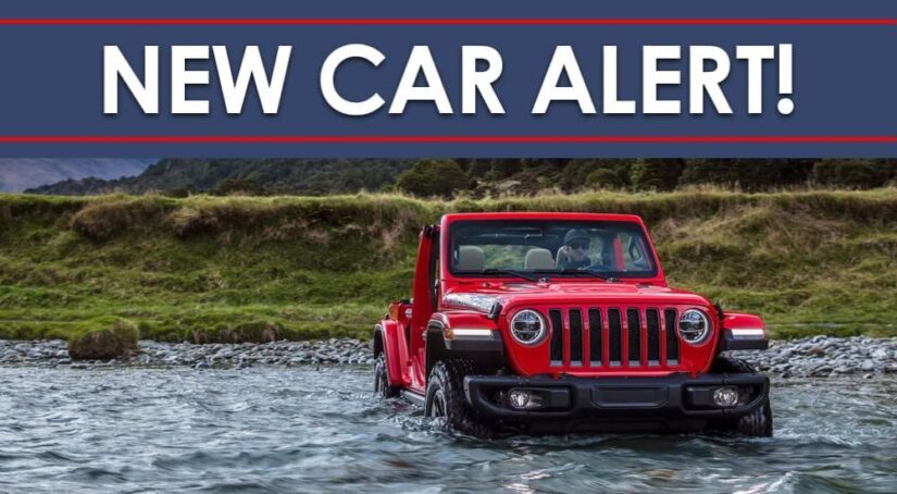 A red 2023 Jeep Wrangler is shown under a new car alert banner.