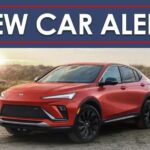 A red 2024 Buick Envista ST is shown on a beach under a new car alert banner.