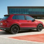 A red 2023 Volkswagen Tiguan for sale is shown from the side.