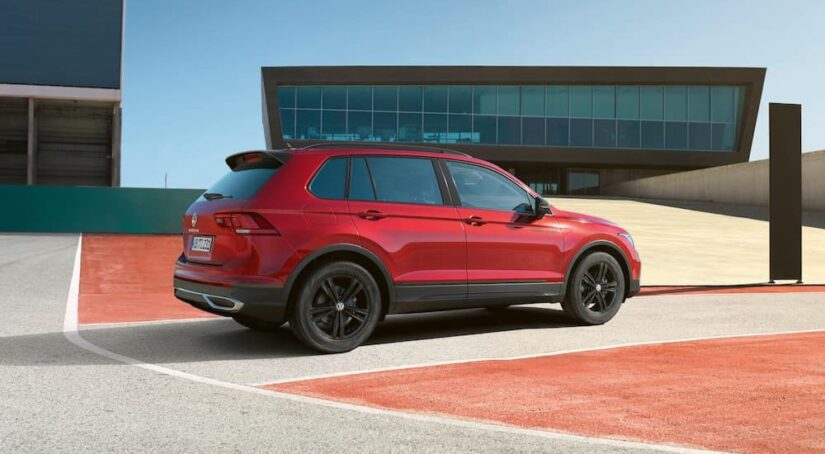 A red 2023 Volkswagen Tiguan for sale is shown from the side.