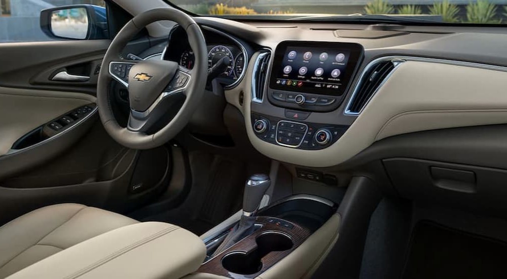 The tan interior and dash of a 2020 Chevy Malibu is shown.