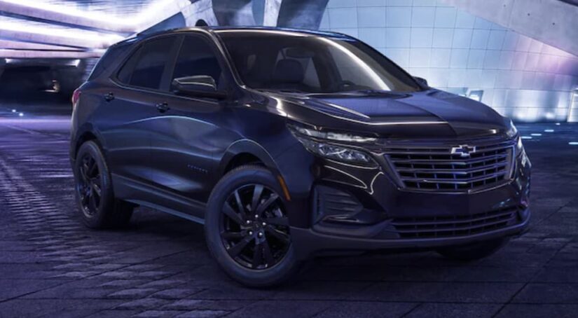 A black 2023 Chevy Equinox Midnight Edition is shown parked.