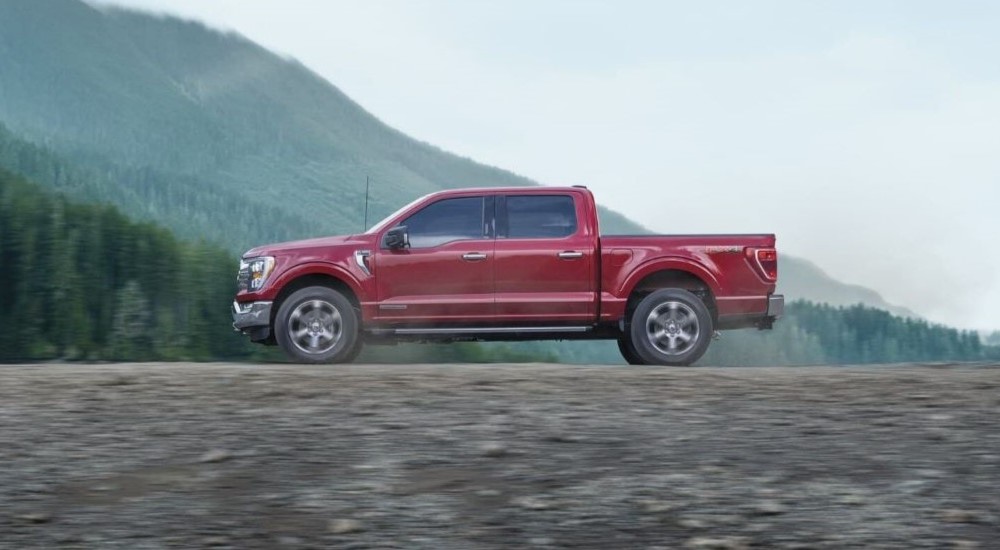 A red 2023 Ford F-150 is shown from the side after participating in a 2023 Chevy Silverado 1500 vs 2023 Ford F-150 comparison.