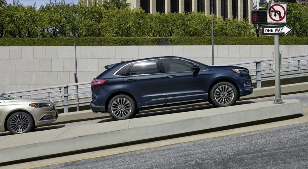 A blue 2023 Ford Edge ST is shown stopped on a road.