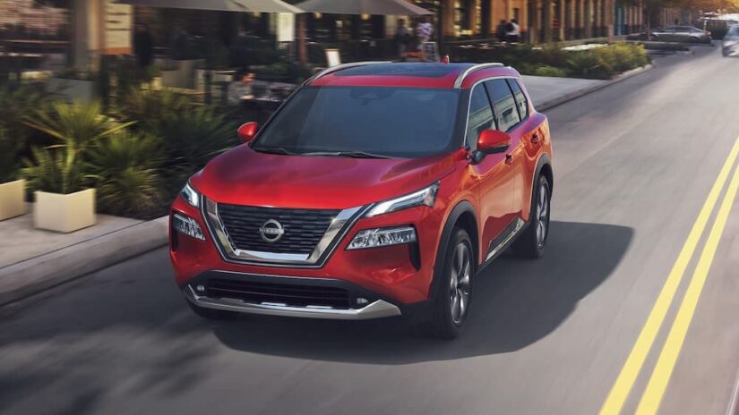 A red 2023 Nissan Rogue is shown driving after winning a 2023 Nissan Rogue vs 2023 Subaru Forester comparison.
