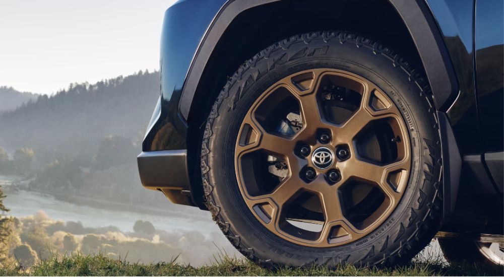 The bronze colored wheel of a 2023 Toyota RAV4 Woodland Edition is shown.