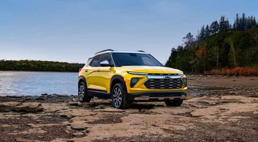 A yellow 2024 Chevy Trailblazer Activ is shown parked beside a lake.