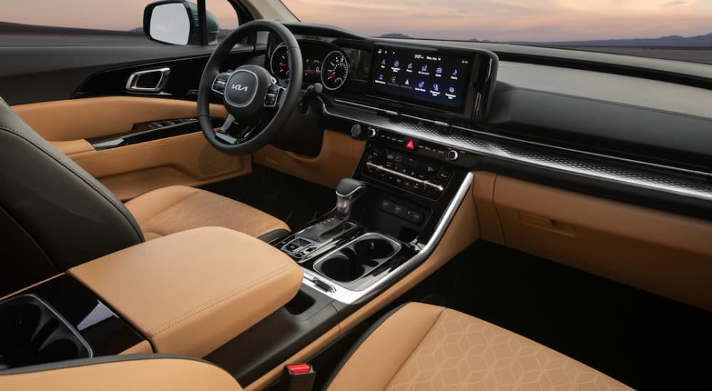 The interior of the 2023 Kia Carnival is shown with Tuscan Umber leather seats.