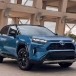 A blue 2023 Toyota RAV4 for sale is shown parked inside of a parking garage.