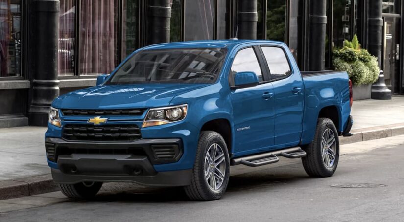 A blue 2022 Chevy Colorado is shown to be parked near a used Chevy dealer in Chamblee, GA.