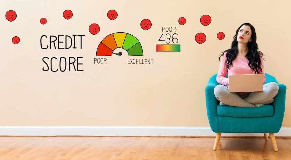 A woman is shown checking her credit score.