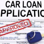 An approved car loan application is shown at a used car dealership.