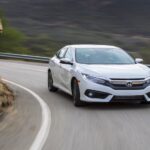 A white 2017 Honda Civic is shown rounding a corner.