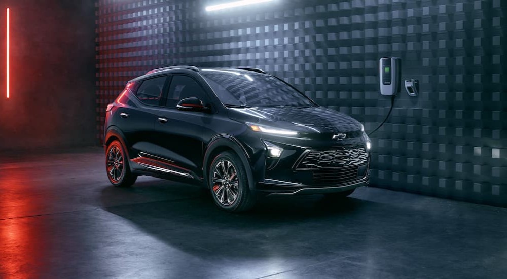 A black 2023 Chevy Bolt EUV Redline Edition is shown charging.