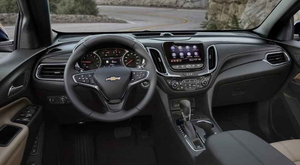 The black interior and dash of a 2023 Chevy Equinox is shown.