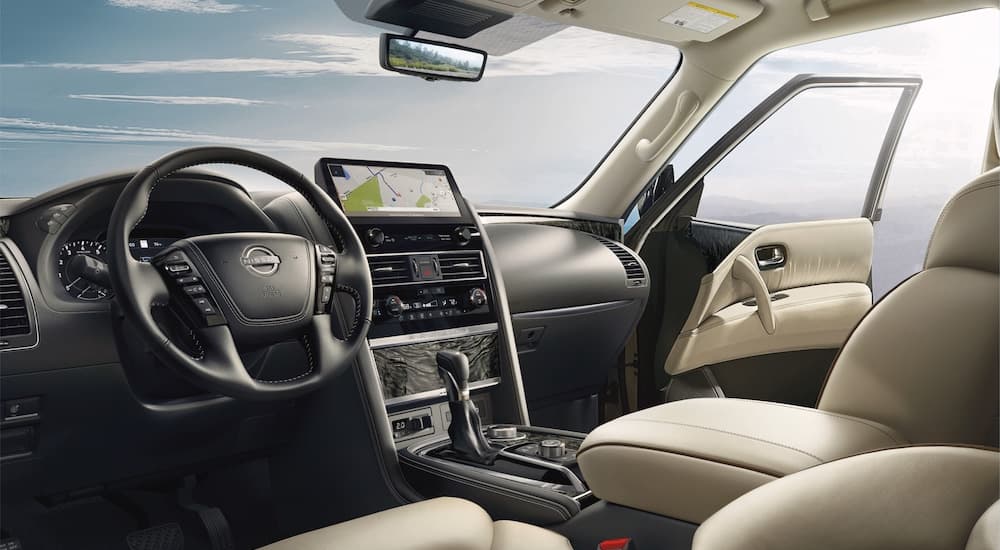 The black and tan interior and dash of a 2023 Nissan Armada is shown.