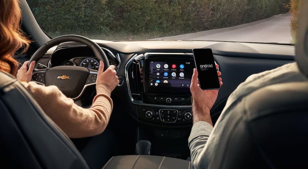 The black interior and dash of a 2023 Chevy Traverse is shown.