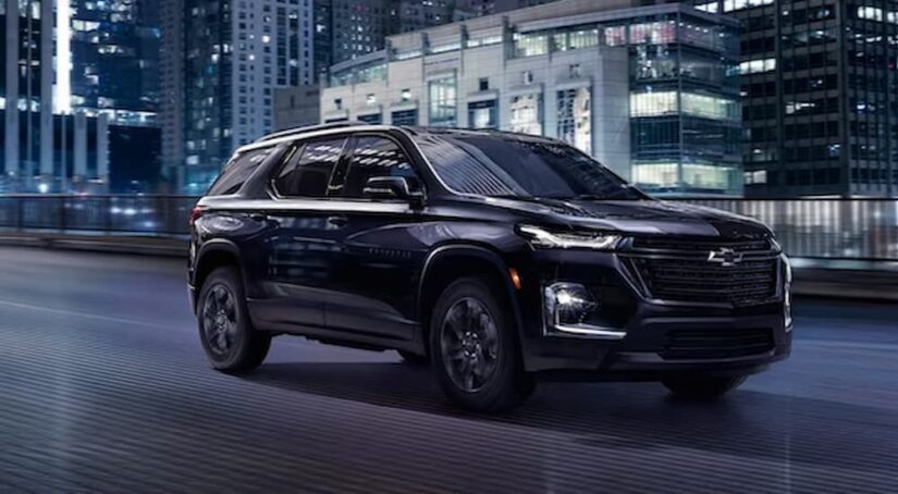 A black 2023 Chevy Traverse Midnight Edition is shown driving after winning a 2023 Chevy Traverse vs the 2023 Kia Telluride comparison.