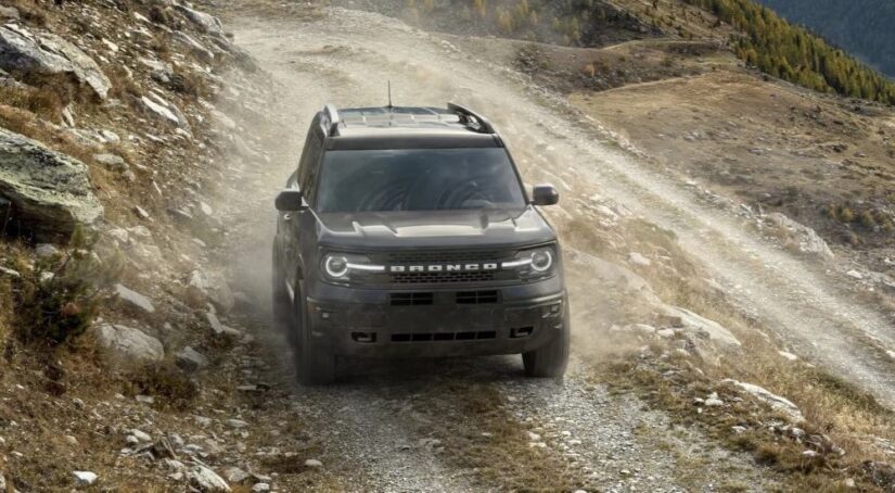 A gray 2023 Ford Bronco Sport Badlands is shown driving off-road.