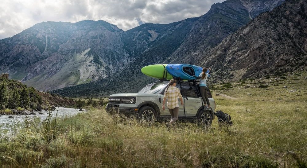 A gray 2023 Ford Bronco Sport Outer Banks is shown parked near a mountain.