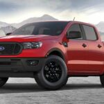 A red 2023 Ford Ranger STX is shown parked near mountains.