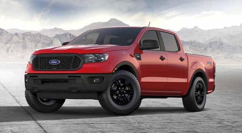 A red 2023 Ford Ranger STX is shown parked near mountains.