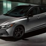 A silver and black 2023 Nissan Sentra Midnight Edition is shown parked in a hangar.