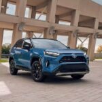 A blue 2023 Toyota RAV4 Hybrid XSE is shown parked.