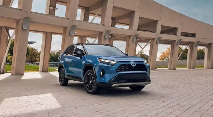A blue 2023 Toyota RAV4 Hybrid XSE is shown parked.