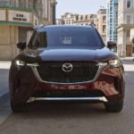 The grille of a burgundy 2024 Mazda CX-90 is shown.
