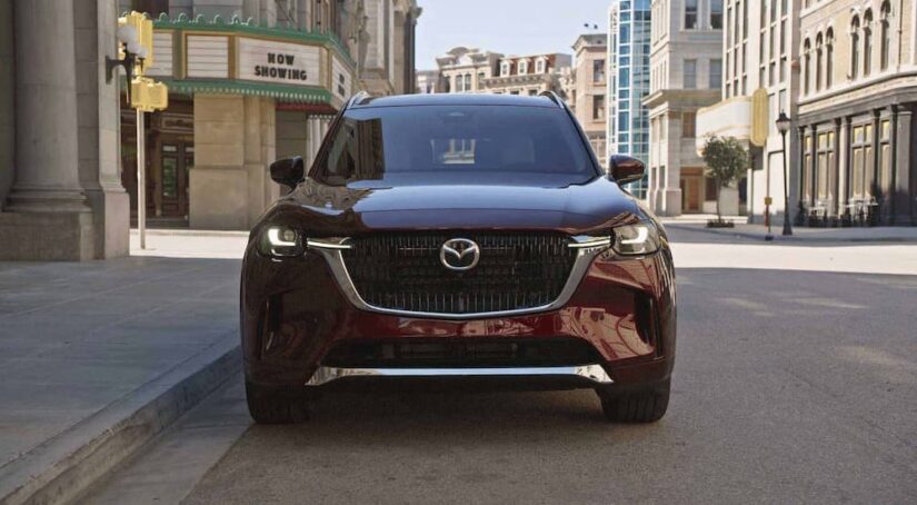 The grille of a burgundy 2024 Mazda CX-90 is shown.