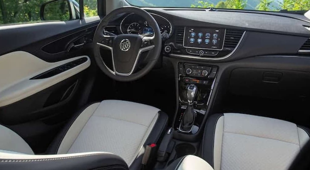 The black and white interior and dash of a 2021 Buick Encore is shown.
