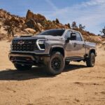 A gray 2024 Chevy Silverado 1500 HD ZR2 is shown parked off-road.