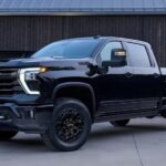 A popular Chevy Silverado for sale, a black 2023 Chevy Silverado 1500 High Country Midnight edition, is shown parked on a driveway.