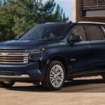 A blue 2023 Chevy Tahoe High Country for sale is shown parked on a driveway.