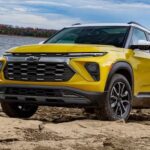 A yellow 2024 Chevy Trailblazer Activ for sale is shown parked near a lake.