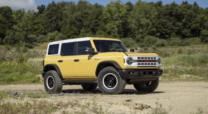 A yellow 2023 Ford Bronco Sport Heritage Limited Edition is shown parked off-road.