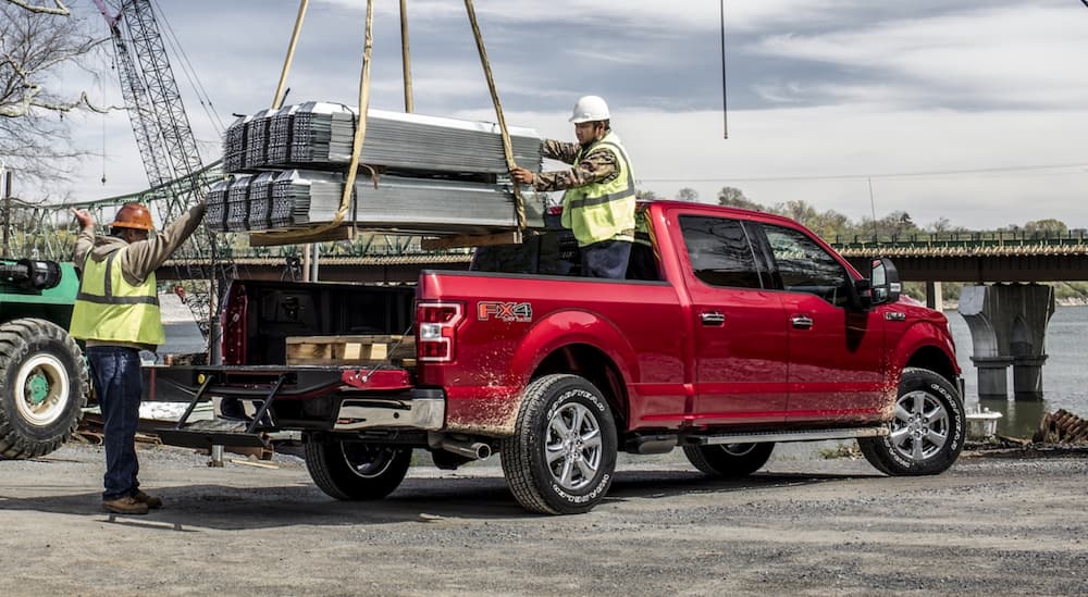 A red 2020 Ford F-150 FX4 is shown parked at a construction site.
