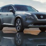 A silver 2023 Nissan Rogue is shown parked off-road after visiting a Nissan Rogue dealer.