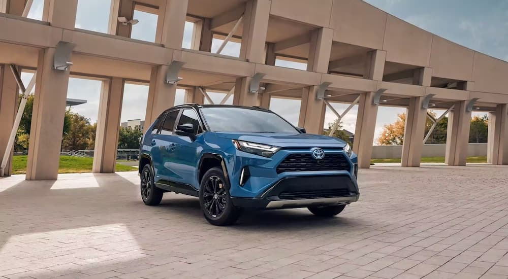 A blue 2023 Toyota RAV4 Hybrid XSE is shown from the front at an angle.