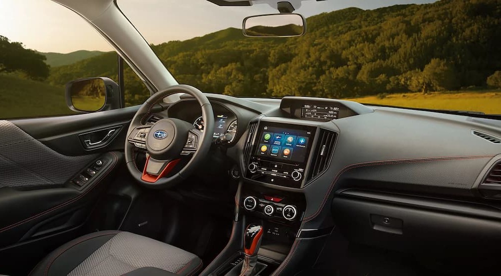The black and gray interior and dash shown of a 2023 Subaru Forester is shown.