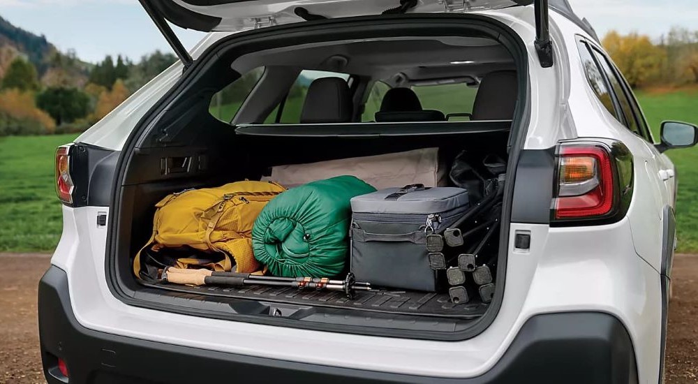 Cargo is shown in the trunk of a white 2024 Subaru Outback.