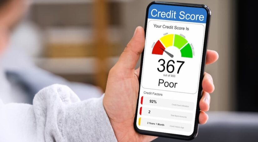 A poor credit score is shown on a cellphone.