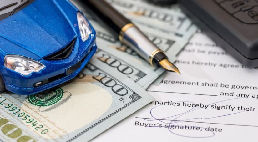 A signature is shown on a subprime auto loan form.