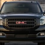 A black 2019 GMC Yukon Graphite Edition is shown parked near a white wall after visiting a used GMC dealer.