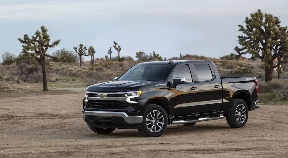 A black 2023 Chevy Silverado 1500 LT is shown from the front at an angle during a 2023 Chevy Silverado 1500 vs 2023 Nissan Titan comparison.