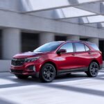 A red 2024 Chevy Equinox RS is shown from the front at an angle.