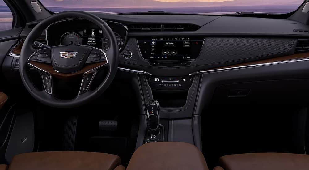 The black and brown interior and dash of a 2023 Cadillac XT6 is shown.