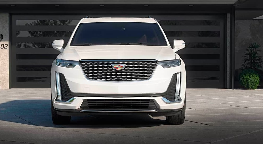 A white 2023 Cadillac XT6 is shown parked on a driveway.